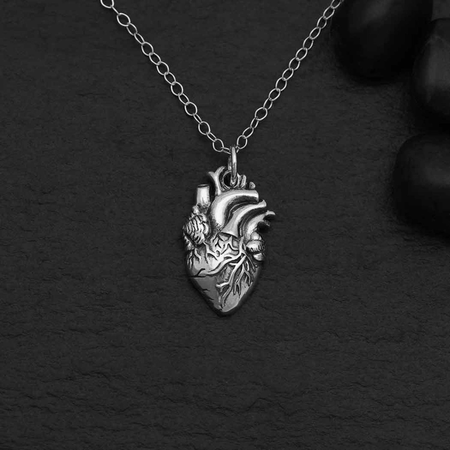 Sterling silver anatomical heart necklace, edgy and romantic charm design.